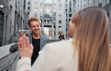 Woman and man in the town at daytime. Well dressed people