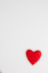 Red heart on a white background. Festive background. Minimalism. Copy space. St. Valentine's Day background. Defocus