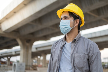 Asian construction workers wearing protective masks for Prevention of coronavirus or covid-19 at a construction site.