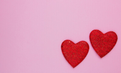 Two red hearts on a pink background. Festive background. Minimalism. Copy space
