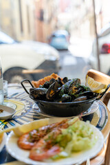 Seafood and fish dishes of clams, shells, mussels and shrimps deep-fried and raw