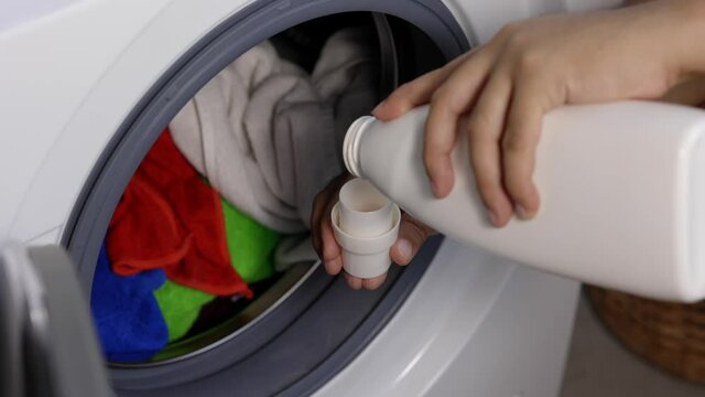 Pour some laundry detergent on the clothes and put it in the washing machine
