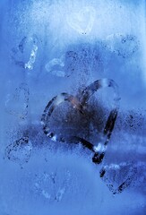 Hearts drawn on the frozen glass window