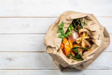 Composting concept - kitchen leftovers in paper bag, copy space