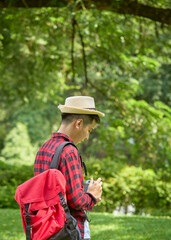 man backpacker stand in a nature park