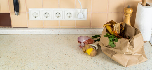 Composting concept - kitchen leftovers in paper bag, copy space