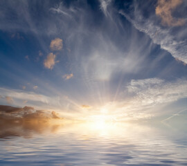 Dawn sunrise landscape out at sea with no land or people. Ocean reflection with amazing clouds and sky. Spiritual and zen concept