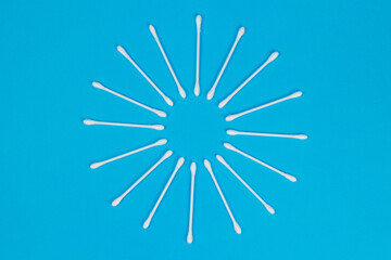 Obraz premium White cotton swabs on blue background.