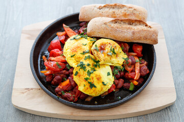 Fried egg with red beans and tomato, breads