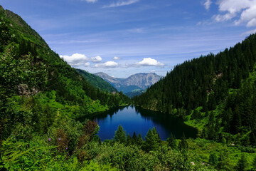 deep blue water with reflection in a mountain lake in the summer