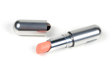 Single opened pastel pink lipstick isolated on white background