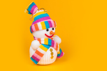 Handmade foam snowman on yellow background
