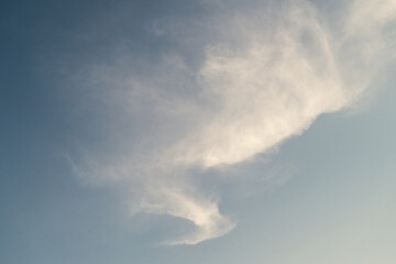 Fototapeta na wymiar Wispy cirrus clouds form a trail