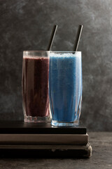 Smoothie glasses with spirulina powder. Fresh banana, blueberry healthy detox drinks.
