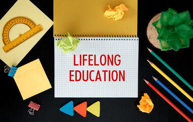 Notebook with school supplies and the inscription Lifelong education