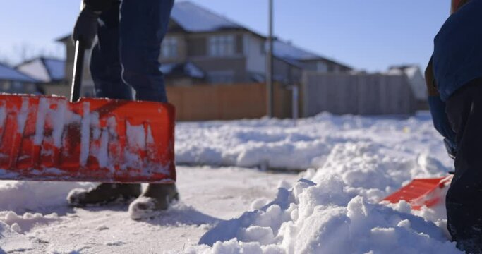 Father and young son shovel snow