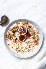 Oatmeal with honey dripper and figues