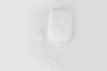 Soap with foam on a white background Soap used in everyday life, including washing, bathing