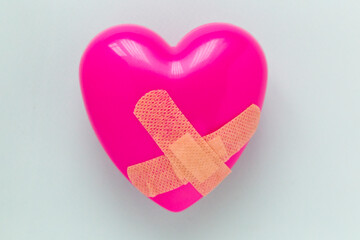 Broken heart patched with a patch. Healing love concept