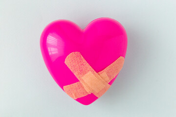 Broken heart patched with a patch. Healing love concept