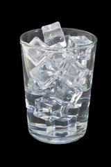 Transparent ice cubes are in a transparent glass on a black background.