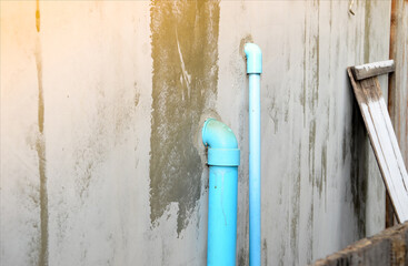 PVC pipes for water delivery, used inside the building, penetrate all walls, installed outside, fixed on the cement wall of the building.