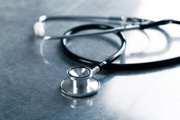 black stethoscope for medical examination on medical laboratory health table background