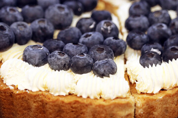 Blueberry pie with cream and fresh berries, selective focus