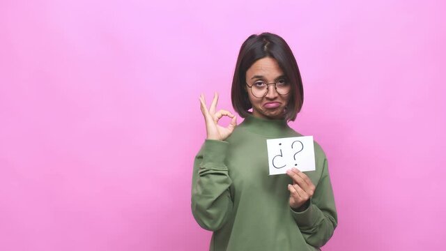 Young hispanic woman holding an interrogation symbol feels proud and self confident, example to follow