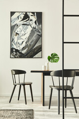 Stylish open space interior with wooden family table, black chairs, cups of coffee,  tropical leaf in vase, abstract painitings on the wall and elegant accessories. Modern home decor. Template.