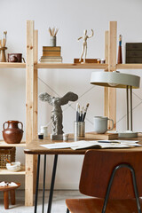 Unique artist workspace interior with stylish desk, wooden easel, bookcase, artworks, painting accessories, decoration and elegant personal stuff. Modern work room for artist. Template.