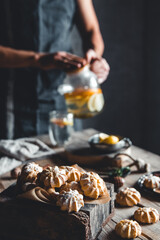 Man pours Hot tea with slices of fresh grapefruit on wooden tablet. Healthy drink, Eco, vegan.