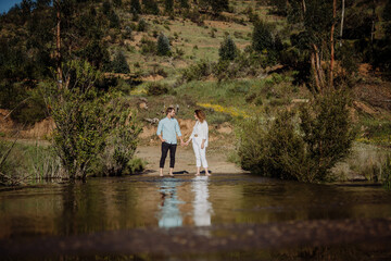 Fototapeta na wymiar Man and woman holding hands in the water Spring time. Love in spring.