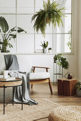 Modern scandinavian interior of living room with design grey sofa, armchair, a lot of plants,...
