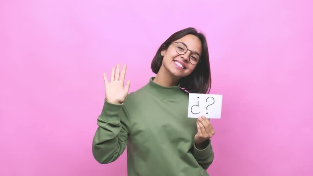 Young hispanic woman holding an interrogation symbol smiling cheerful showing number five with fingers