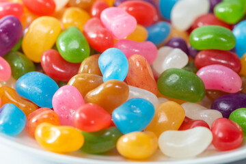 Fototapeta na wymiar A plate of colourful Jelly Beans on a white background