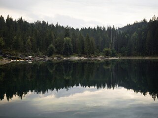 Reflection of clear swiss alpine lake Caumasee Lag la Cauma Lai da Cauma near Flims Grisons...