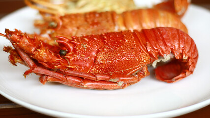 Boiled lobsters on white plate.