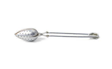 metal vintage tea strainer in a cup isolated on white background