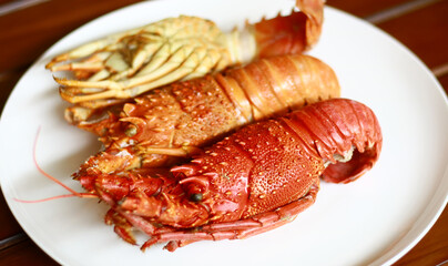 Boiled lobsters on white plate.