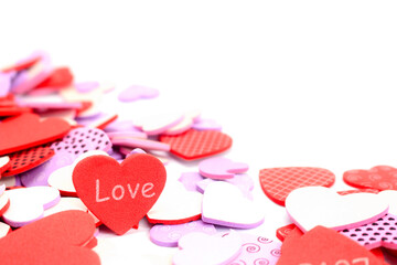 Valentine's Day background. White and red hearts with word love on white background. Valentines day concept. Flat lay, top view, copy space
