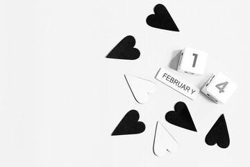 wooden calendar show of February 14 with black and white heart for valentine day background