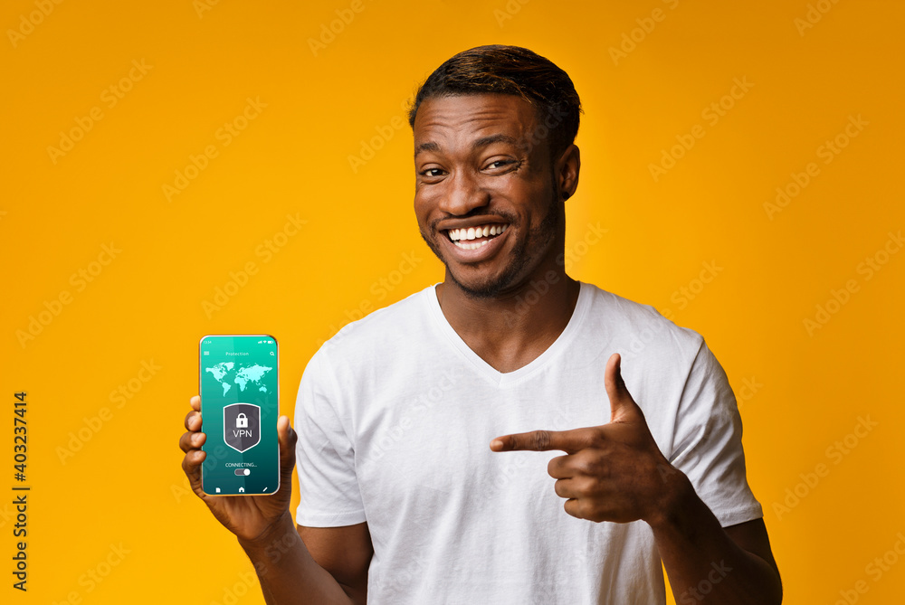 Aufkleber smiling black man holding and showing smartphone with vpn app