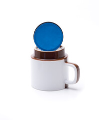 blue coffee capsule on cup