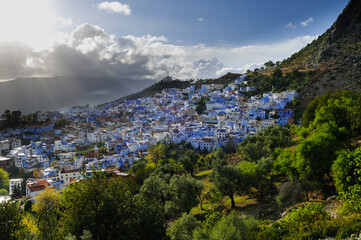 The blue city Chefchaouen / City view of the blue city Chefchaouen with dramatic sky, Morocco,...
