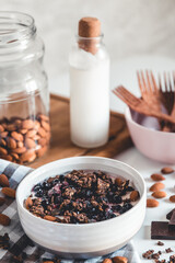 Porridge in a bowl with berries, and coffee
