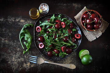 Healthy salad with arugula and cherries. Diet food. Vegan food.