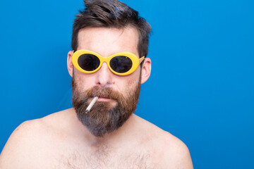 funny young man with sunglasses and cigarette