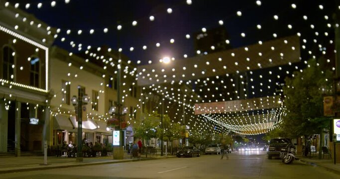 Nightlife Scene At A Denver Street Decorated With Light Bulbs, Cars Leaving Long Light Trails