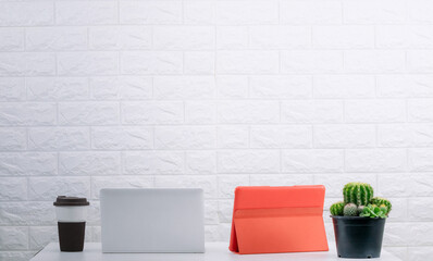 Office desk, tablet computer and coffee mug